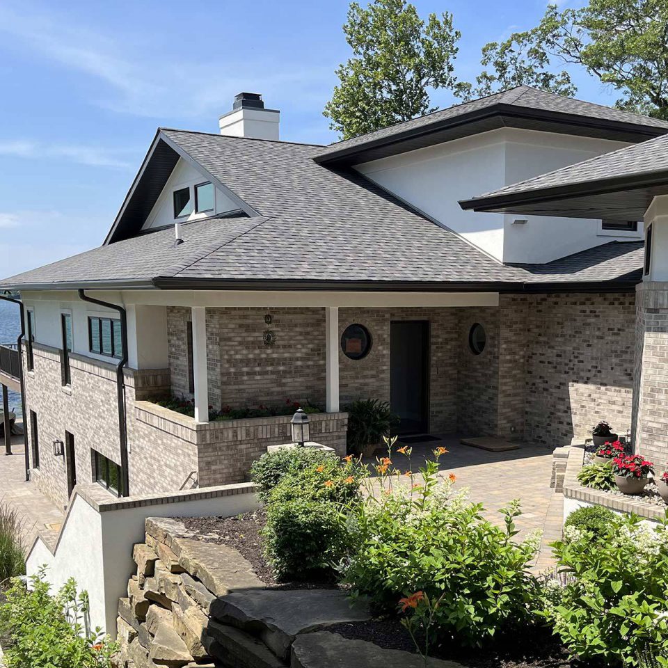 Lakeside home with custom gutter system installed in Winona Lake, IN