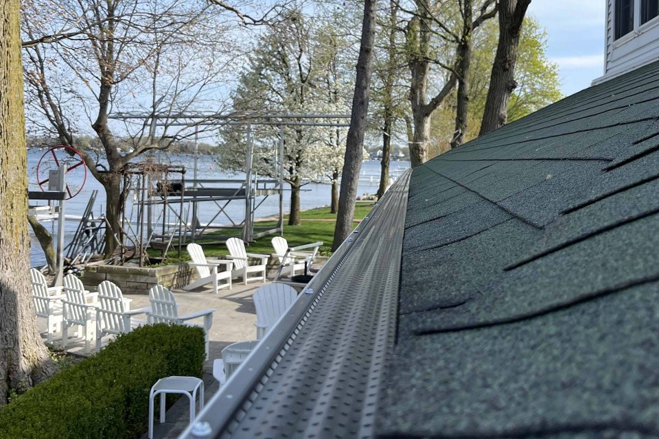 Roof with new gutter guards on it next to Winona Lake, IN